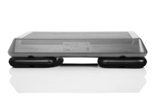 The step original circuit size aerobic stepper platform with grey nonslip platform and two original black risers